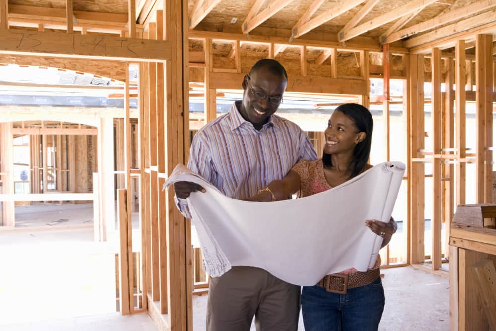 Couple looking at new home blueprints
